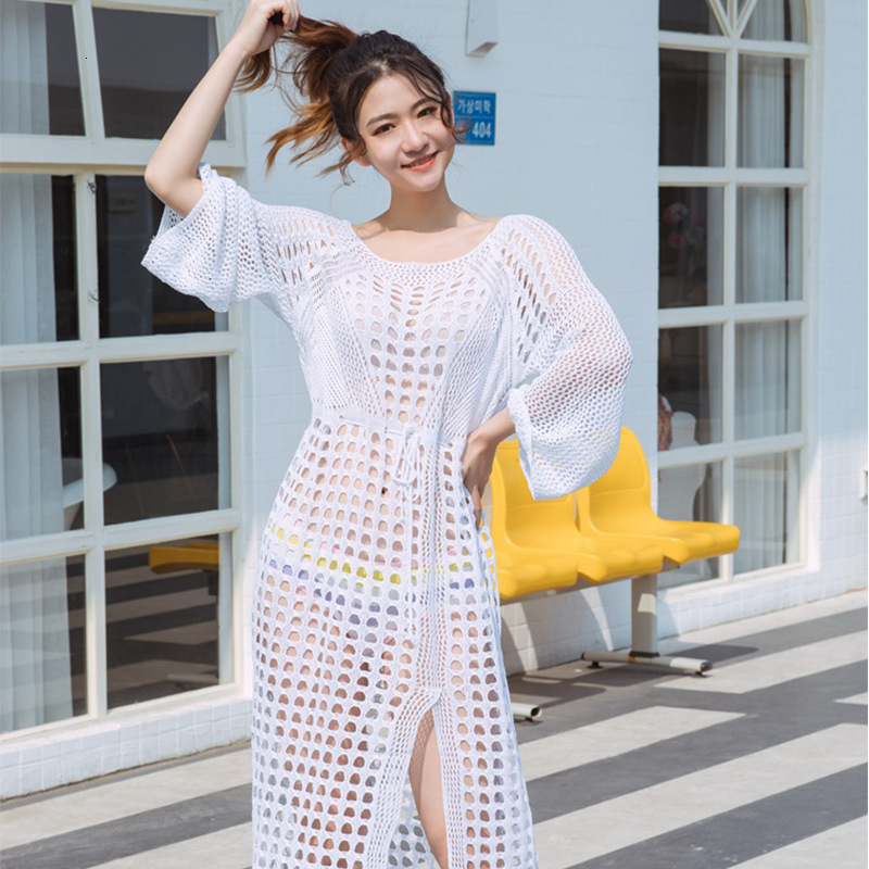 2025 New Women's Clothing Designer White Checkered Long Sleeved Knitted Hollow Beach Skirt Transparent Back Sexy Slit Flared Skirt