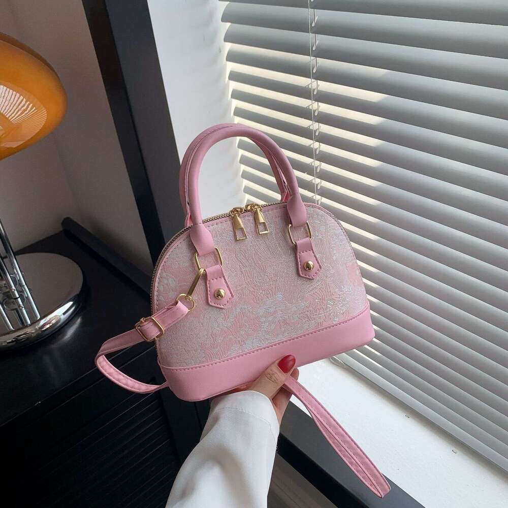 Crossbody casual commuting hand-held shell bag, women's 2025 spring new style, simple and fashionable single shoulder