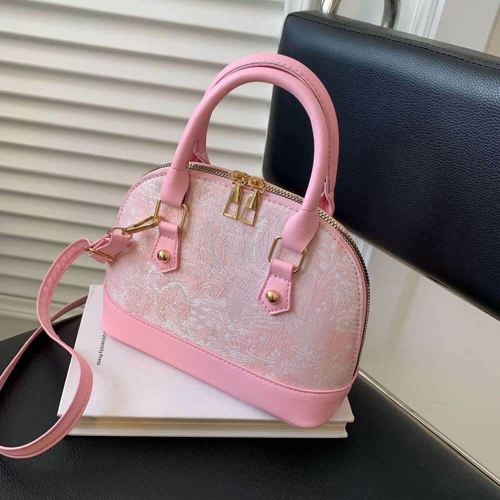Crossbody casual commuting hand-held shell bag, women's 2025 spring new style, simple and fashionable single shoulder