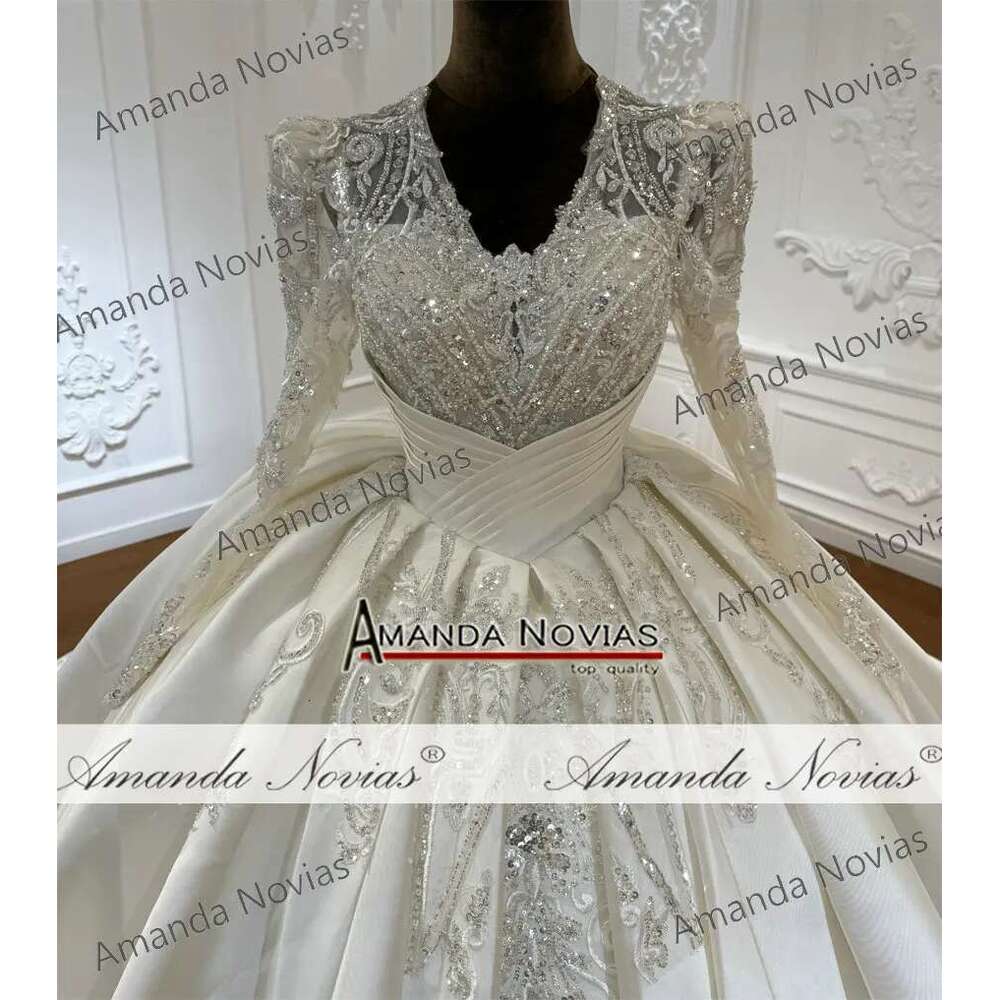 Custom wedding dress with V-neckline and lace beads