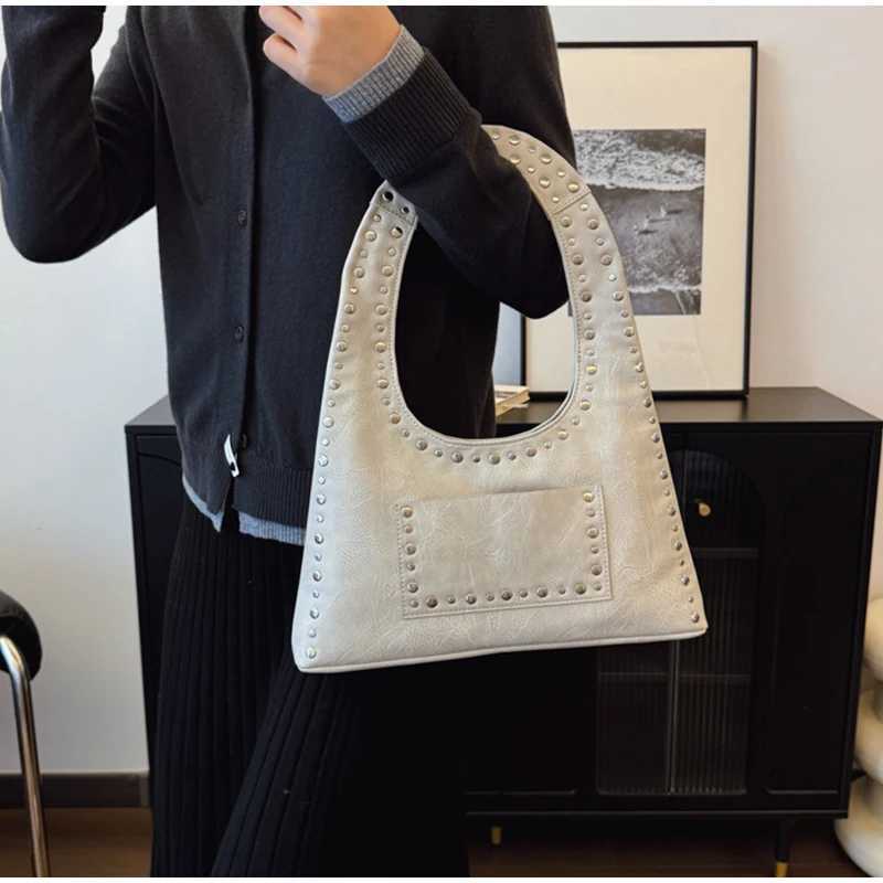 Retro decorative shoulder bag European and American motorcycle style nail wallet leather armrest bag hot womens handbag Y250218