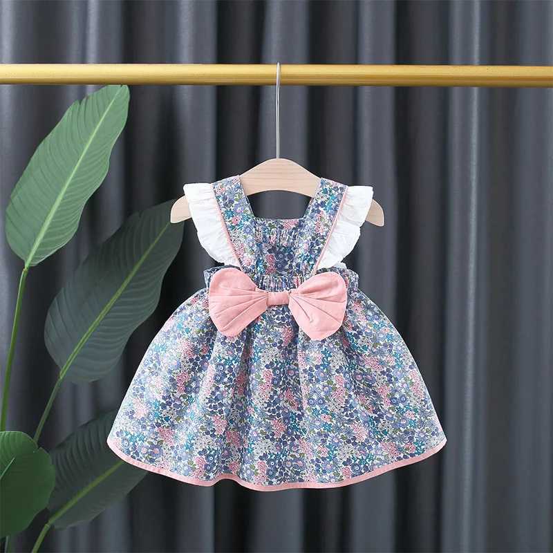 Baby girl floral printed princess dress with white lace on the side and a large bow on the back X250220