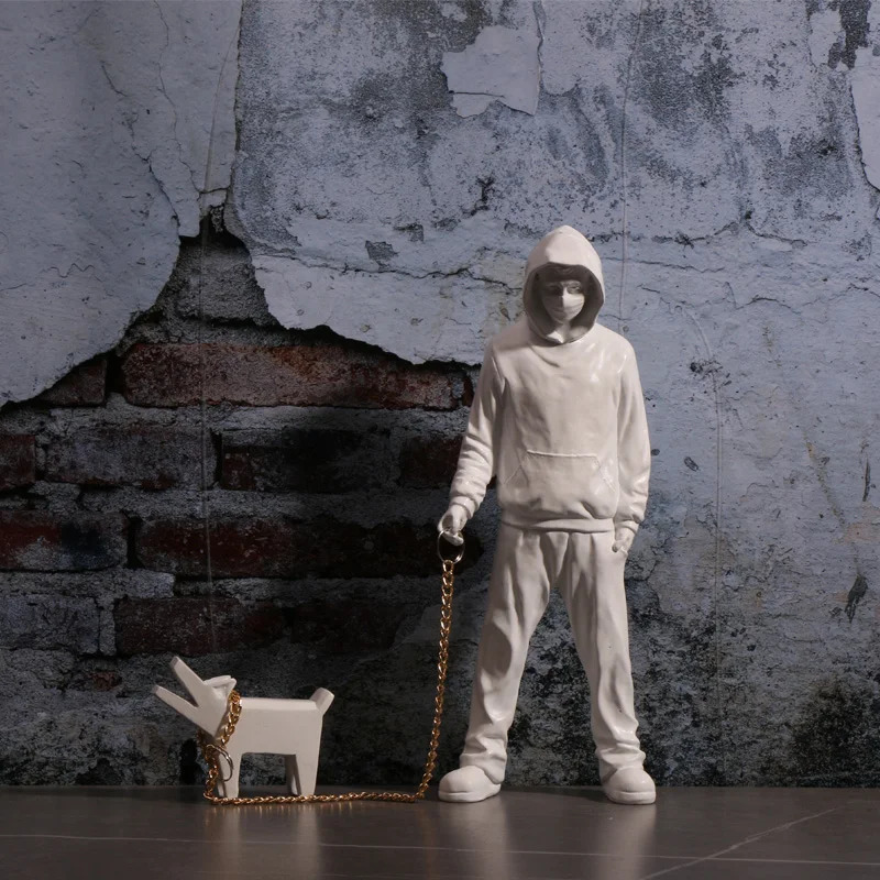 Banksy a trendy man playing with dogs white fashion toys art sculptures and ornaments 250226