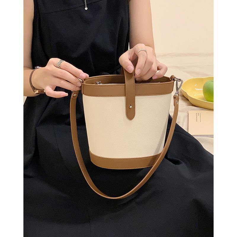 Genuine color blocked small bucket 2024 new niche women's fashionable cloth patterned leather crossbody ba, shoulder