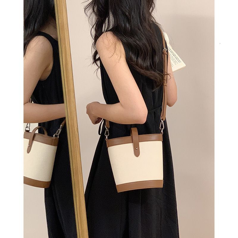 Genuine color blocked small bucket 2024 new niche women's fashionable cloth patterned leather crossbody ba, shoulder