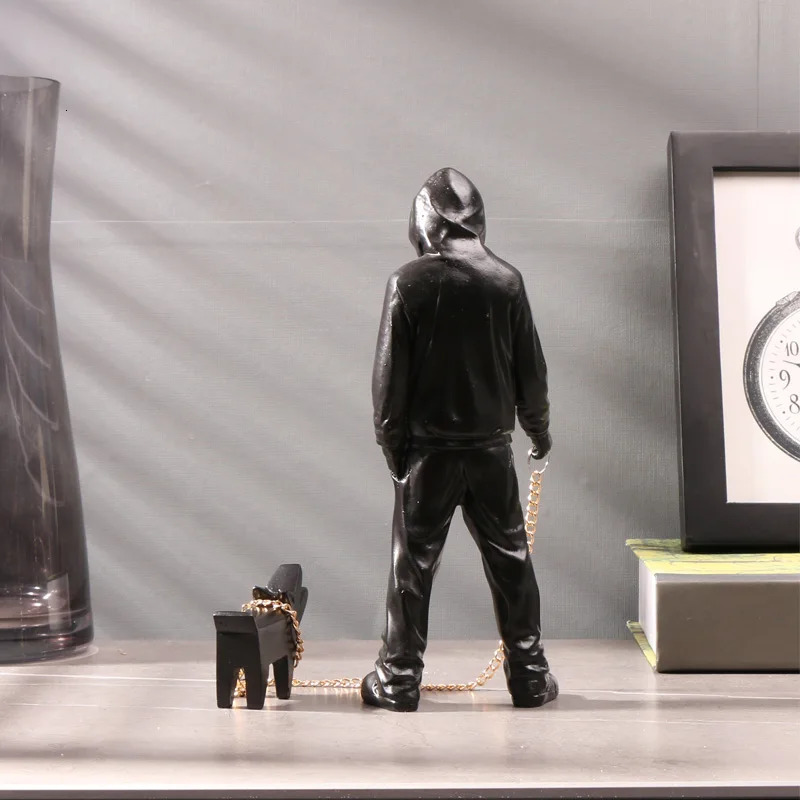 Banksy a trendy man playing with dogs white fashion toys art sculptures and ornaments 250226