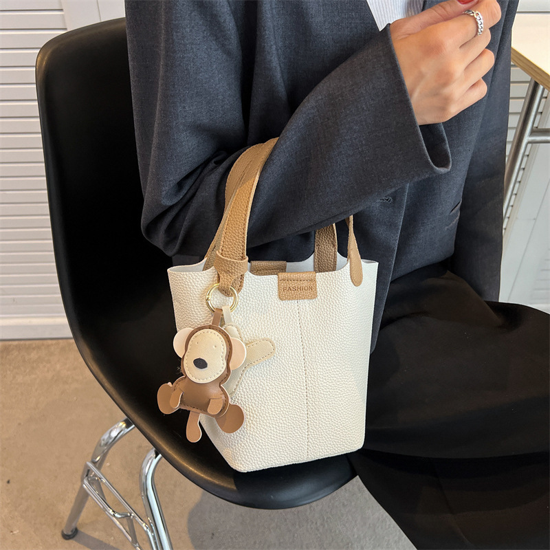 Women's bucket bag new fashionable shoulder bag with cute monkey pendant crossbody bag designer women's crossbody bag