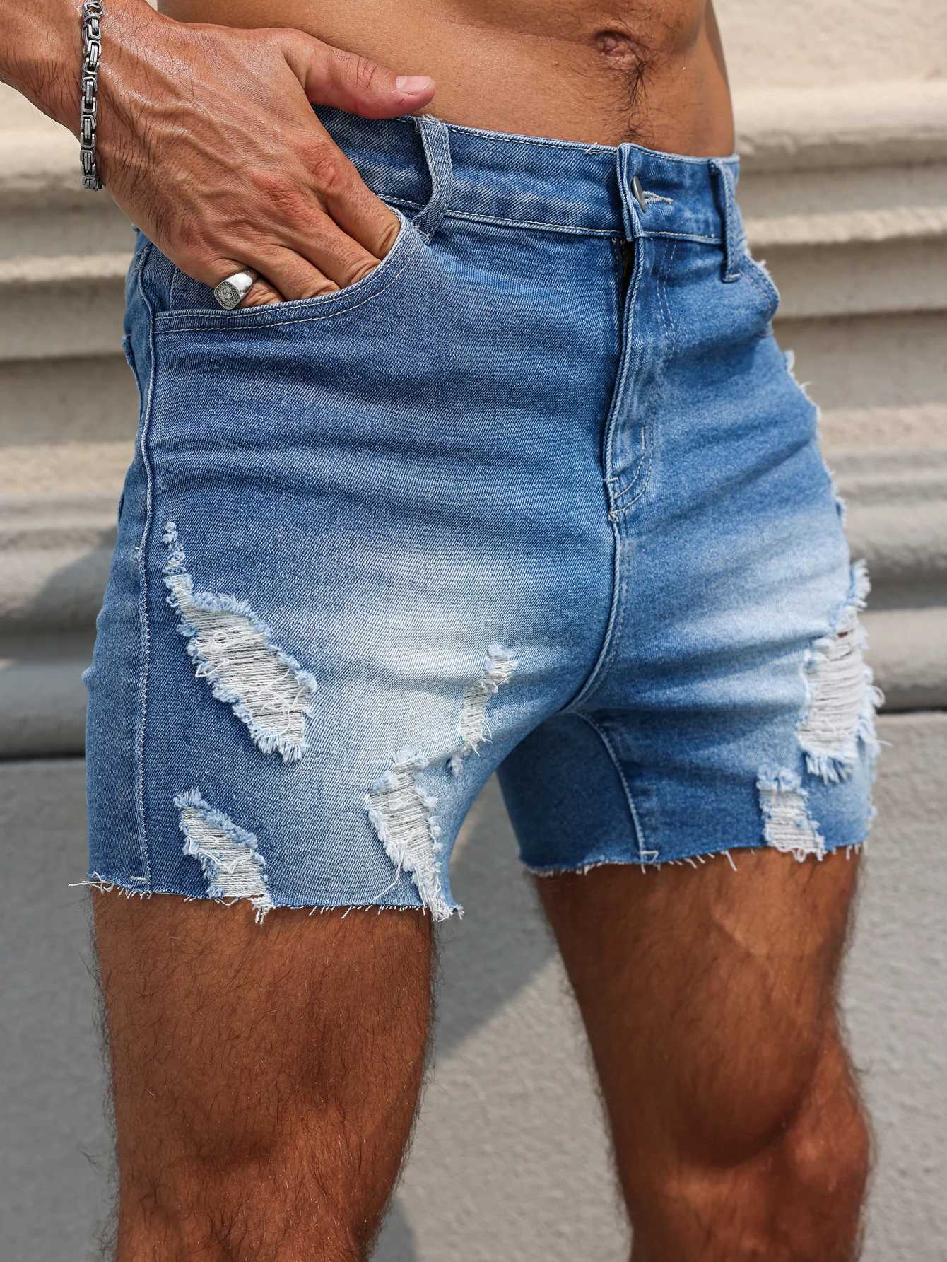 Mens Blue Denim Shorts.The ripped and worn style is popular. T250603