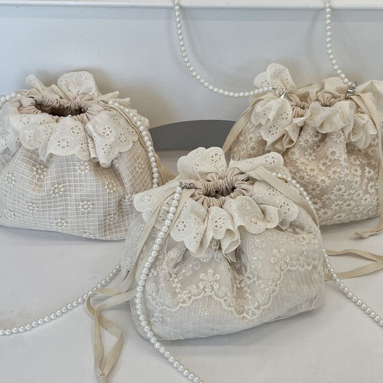 Free Shipping 2025S designer new trendy and fashionable armpit lace versatile drawstring bucket shoulder crossbody pearl strip women small bag