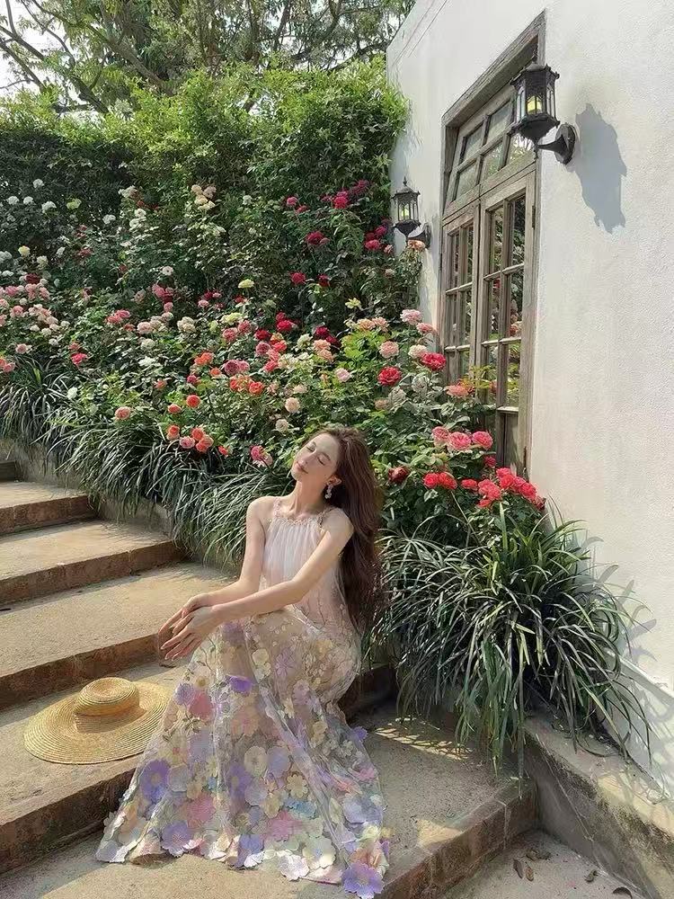 A three-dimensional floral French halter dress with a Monet Garden vacation style and a beach vacation vibe