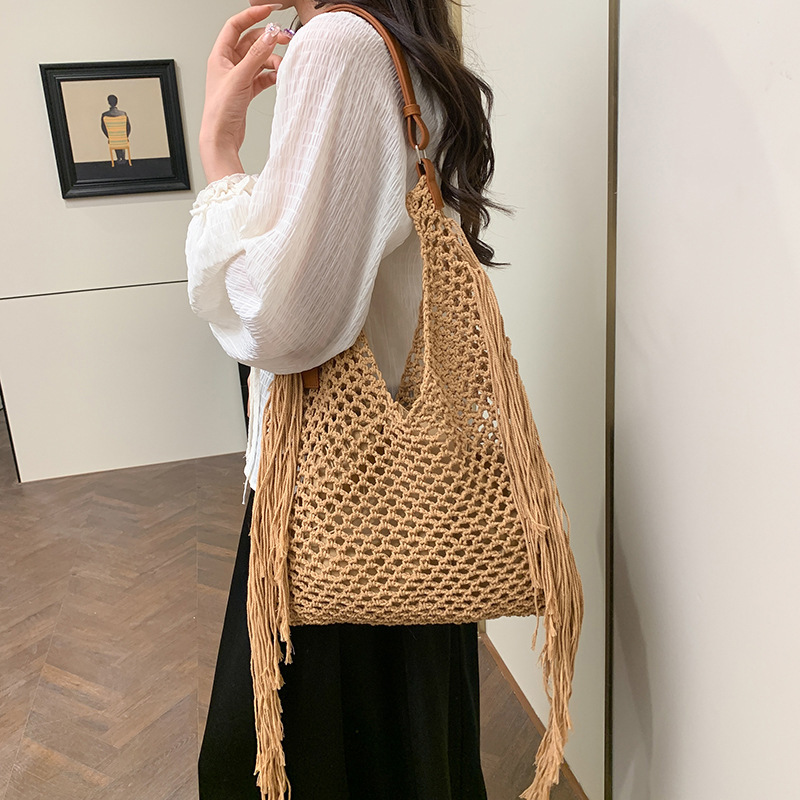 designer Hollow Handwoven Beach Bag for Women 2025 New Commuter Versatile Retro Tassel Vacation Style Single Shoulder Bucket Bag