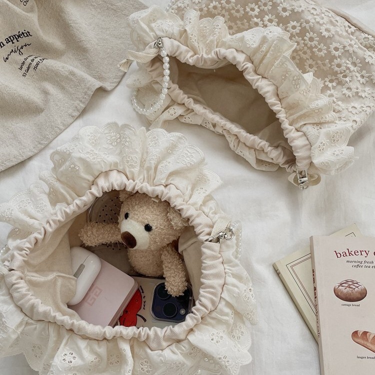 Free Shipping 2025S designer new trendy and fashionable armpit lace versatile drawstring bucket shoulder crossbody pearl strip women small bag