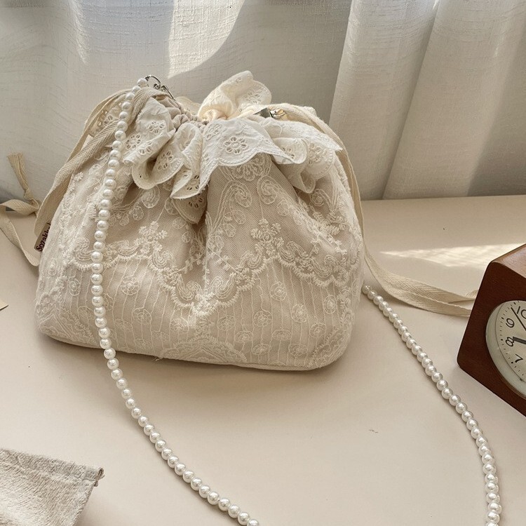 Free Shipping 2025S designer new trendy and fashionable armpit lace versatile drawstring bucket shoulder crossbody pearl strip women small bag