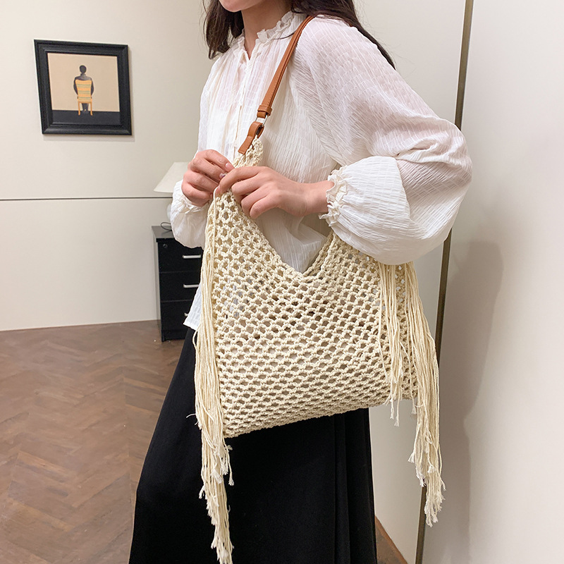 designer Hollow Handwoven Beach Bag for Women 2025 New Commuter Versatile Retro Tassel Vacation Style Single Shoulder Bucket Bag