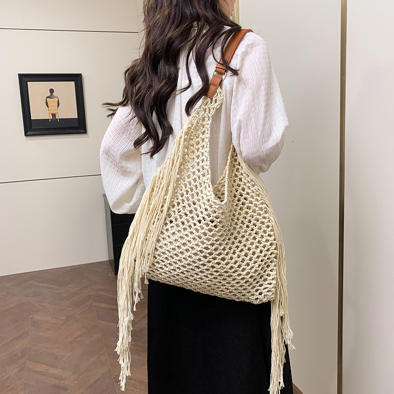 designer Hollow Handwoven Beach Bag for Women 2025 New Commuter Versatile Retro Tassel Vacation Style Single Shoulder Bucket Bag