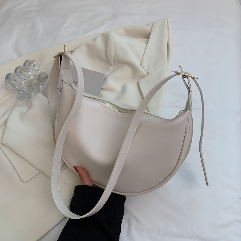 New women's four season bag with simple and multifunctional design, niche office commuting shoulder width dumpling bag designer shoulder bag