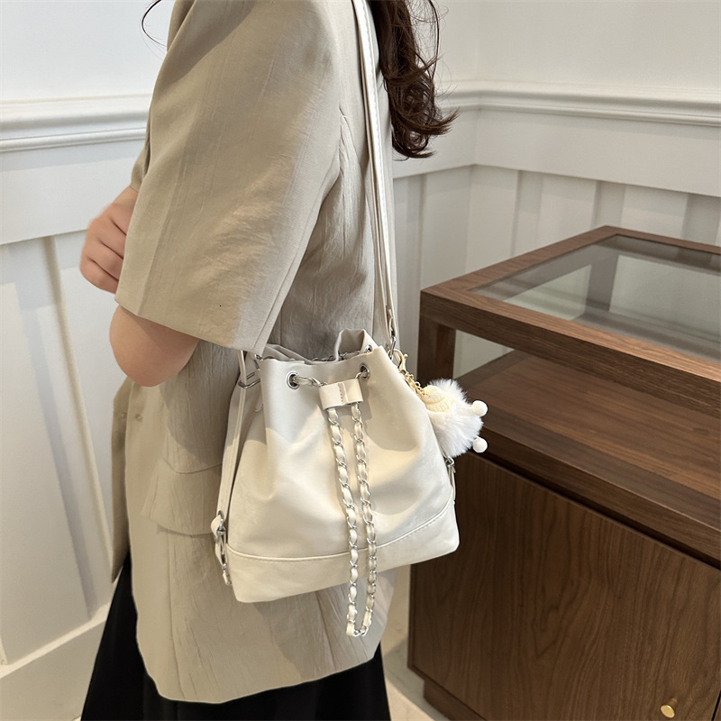 Women s bucket trend bag new trend niche design women s chain backpack designer fashionable slanted white backpack shoulder bag