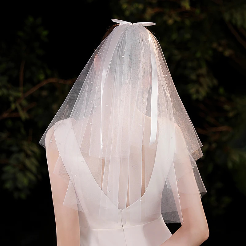 Elegant white minimalist bridal veil suitable for womens weddings with a waist length veil excluding model earrings 250610