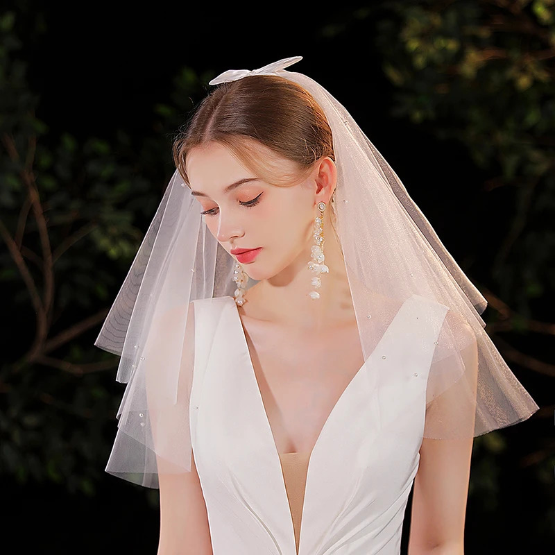 Elegant white minimalist bridal veil suitable for womens weddings with a waist length veil excluding model earrings 250610