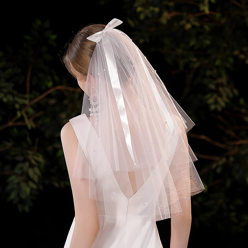 Elegant white minimalist bridal veil suitable for womens weddings with a waist length veil excluding model earrings 250610