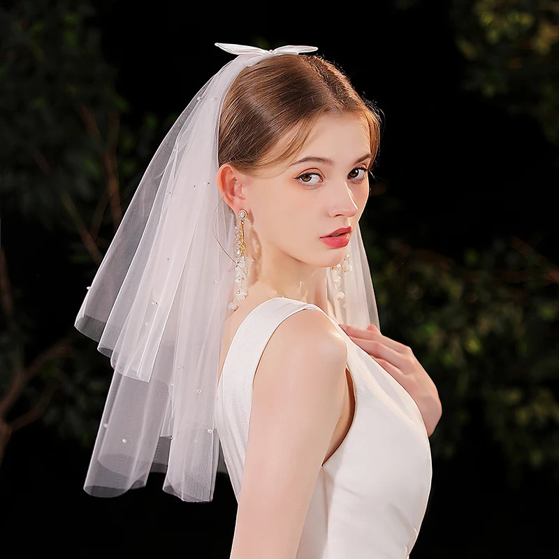 Elegant white minimalist bridal veil suitable for womens weddings with a waist length veil excluding model earrings 250610