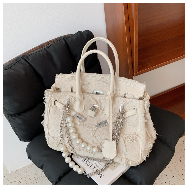 Free Shipping 2025 New Designer Bag Fashionable And High-quality Shopping Bag Pearl Retro Beggar Fabric Platinum Shoulder Width Handbag