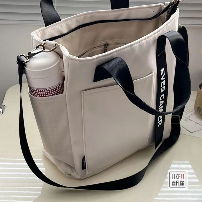 Free Shipping 2025 New Designer Bag Waterproof Canvas Fashion Handbag Simple Multi Functional Shoulder Bag Handheld Leisure High Quality Shopping Bag