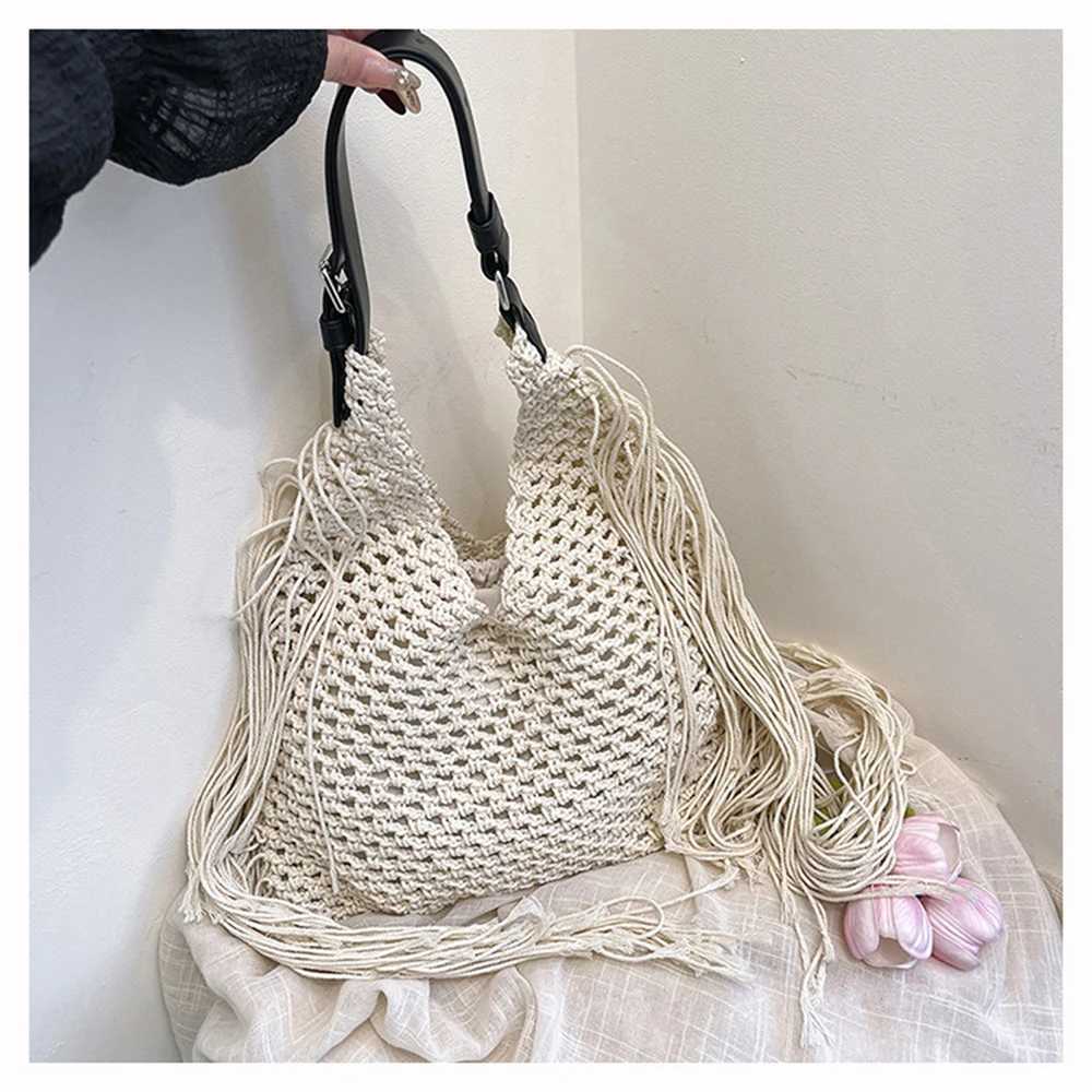 Womens Spring 2025 New Simple Hollow Woven Bohemian Tassels Tote Bag Casual Beach Vacation Style Single Shoulder Beach Bag XJ250620
