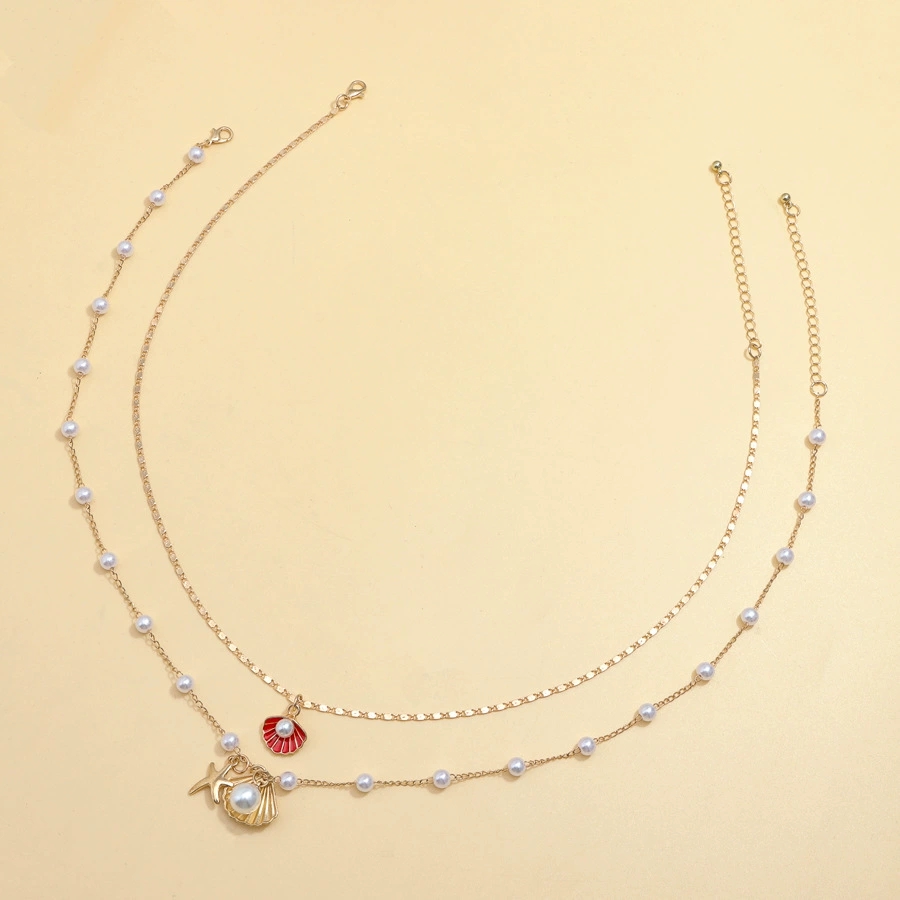 Luxurious Beach-Themed Pearl Necklace Ensemble - Unique Combining Realistic Seashell Molds And Gleaming Gold Finishes