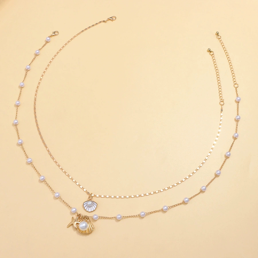 Luxurious Beach-Themed Pearl Necklace Ensemble - Unique Combining Realistic Seashell Molds And Gleaming Gold Finishes