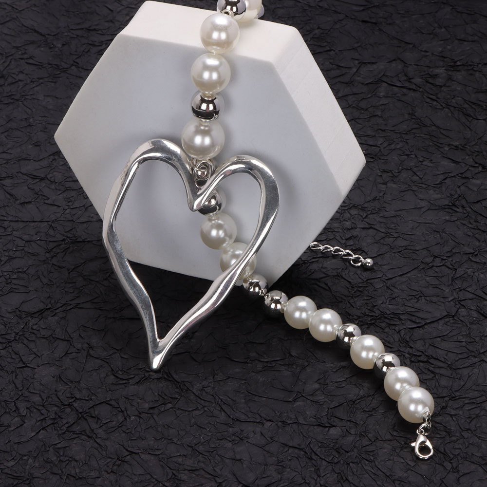 Chic Earrings Set: Bold Lava Heart Pendants Complementing Delicate Pearls