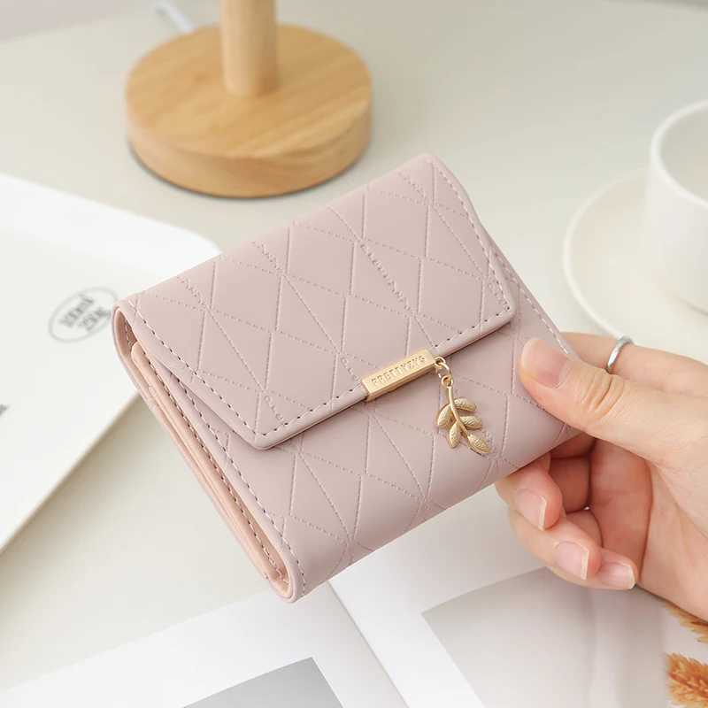Autumn and winter new womens short wallet Japan and South Korea small fresh PU simple folding hardware leaf pendant three foldXJ250624