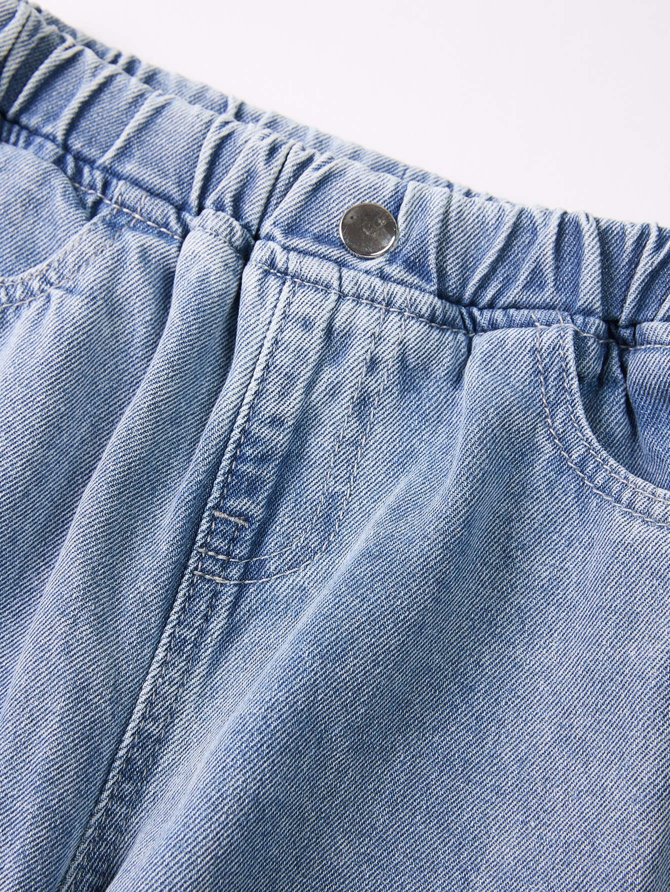 Cute Kid's Lightweight Indigo Trousers Complemented by an Elegant Black Knot Embellishment