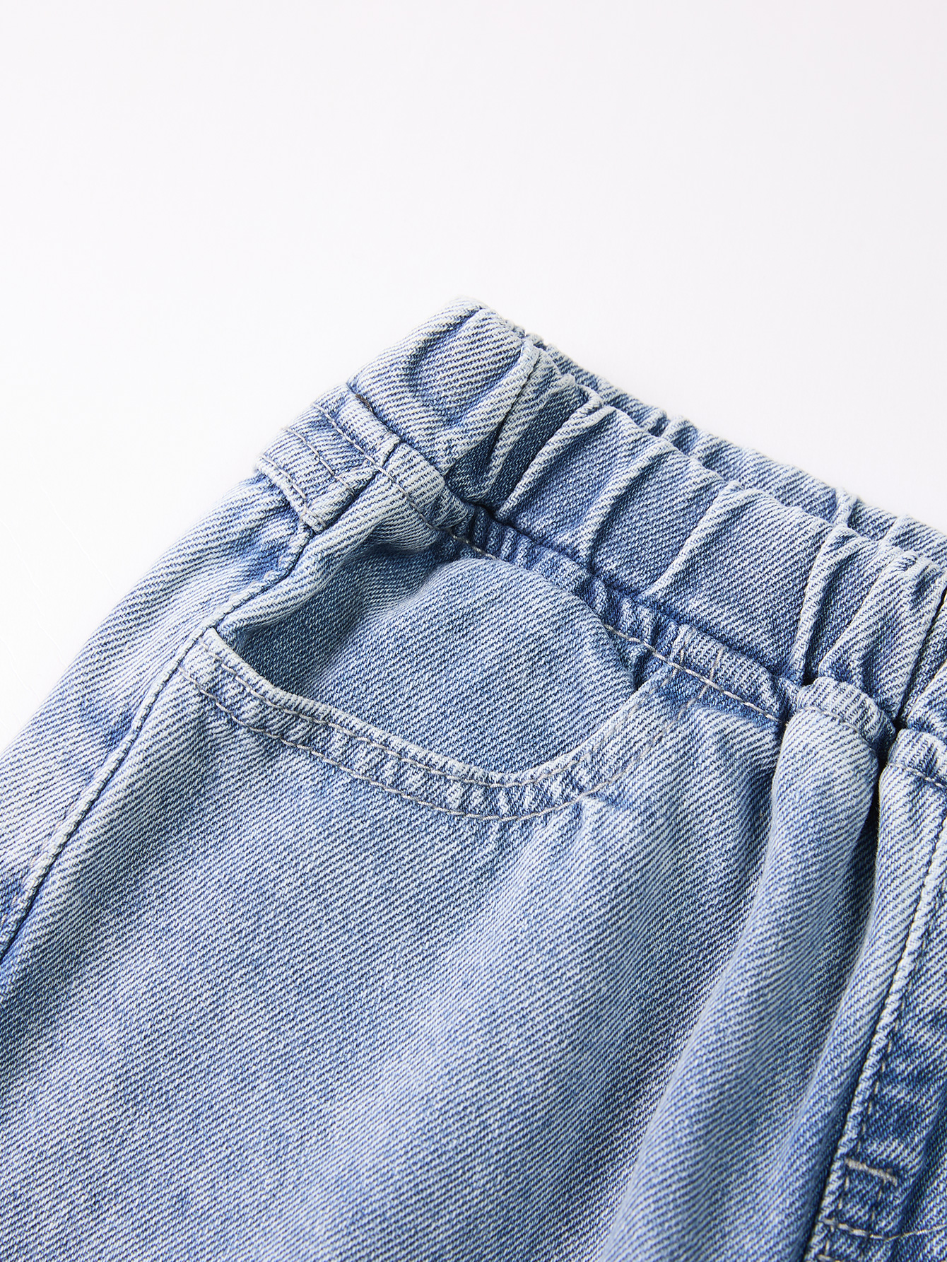 Cute Kid's Lightweight Indigo Trousers Complemented by an Elegant Black Knot Embellishment