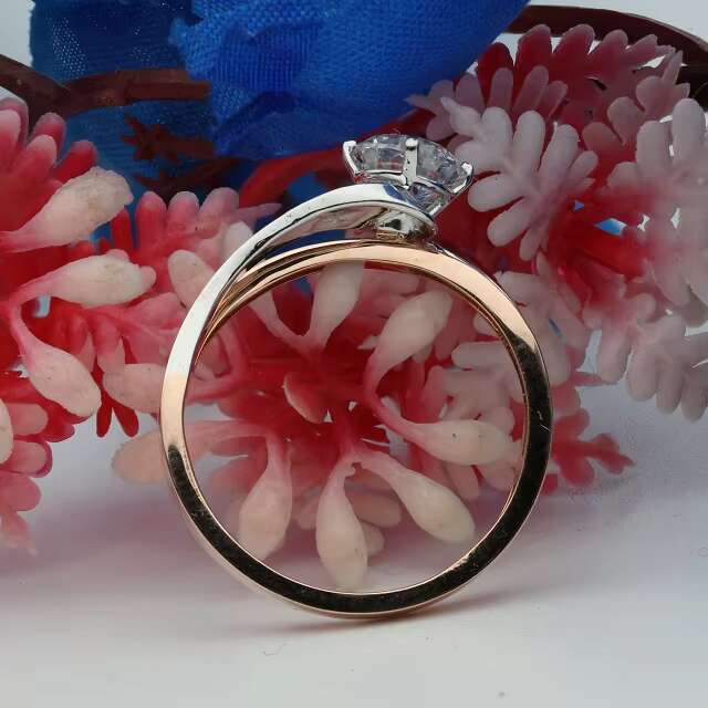 Sophisticated Unisex Designer Gemstone Jewelry Piece Featuring a Versatile Oval-Shaped Stone Embedded in Robust Yellowish-Pink Alloy