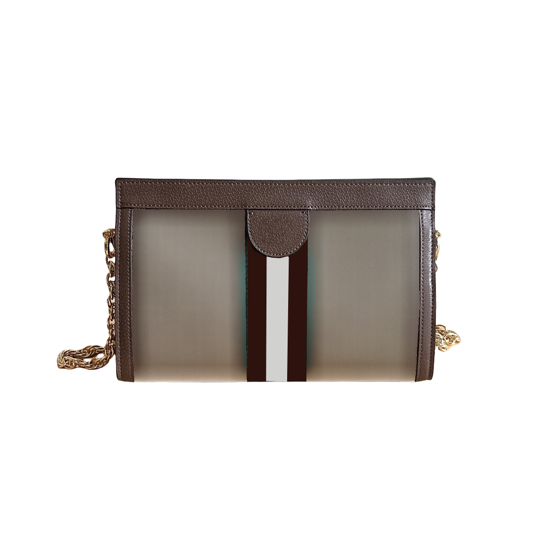 Elegant compact designer shoulder bag; mixed materials; denim and leather cross-body carry bag.