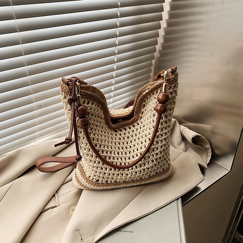 designer bag 2025 new Women's Hollow Knitted Handbag for Beach Vacation A Large-capacity Shoulder and Underarm Bag Woven on the Beach