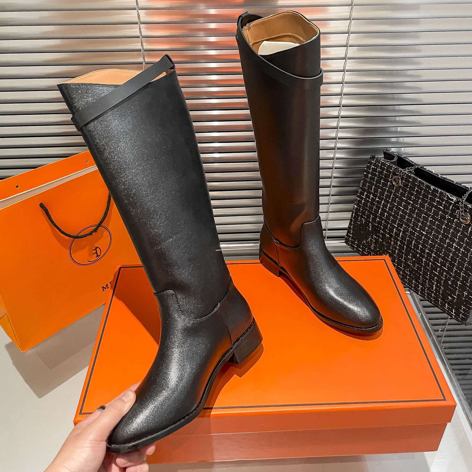 In the new autumn-winter women's knee-high stiletto boots with chain fashion show by French designers the heels of the women's boots are equipped with belts