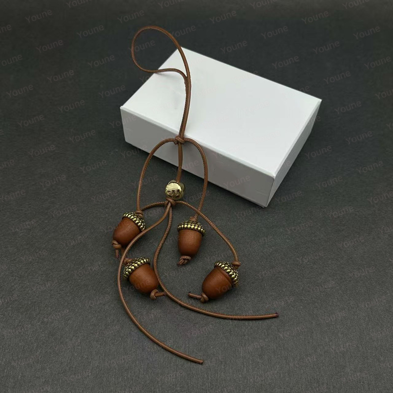 Fashion Bag Charms Designer For Women tomato Berry Acorn charm wood and Metal Leather strap Anagram Pebble dice Ornament Keychain Creative Spherical Shape Pendant