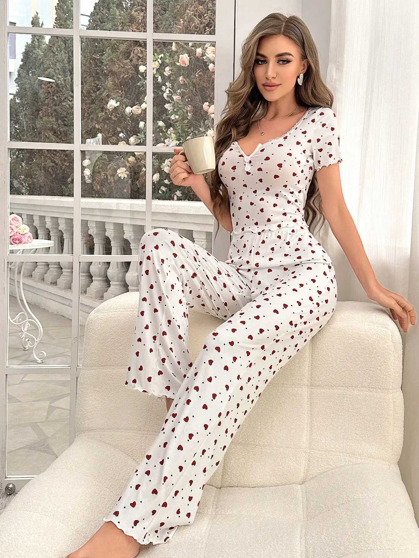 Comfortable pajama set featuring a heartshaped printed short sleeved top and elastic waistband with lotus edges suitable forT251014