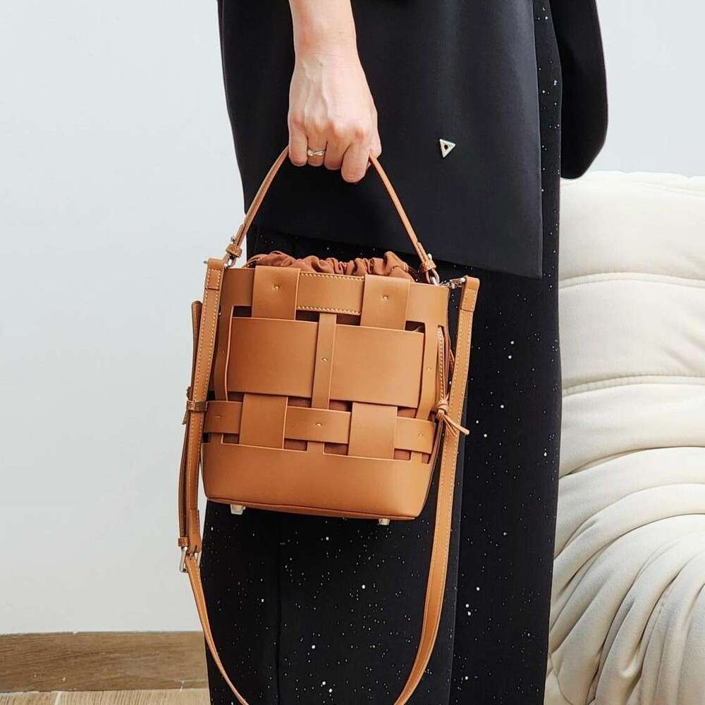 Luxury bag New Handwoven Bucket Niche Design Cowhide Hollow Casual Handheld Shoulder Crossbody Women s Bag