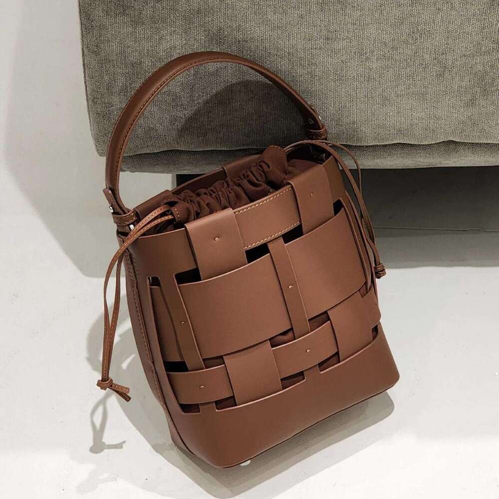 Luxury bag New Handwoven Bucket Niche Design Cowhide Hollow Casual Handheld Shoulder Crossbody Women s Bag