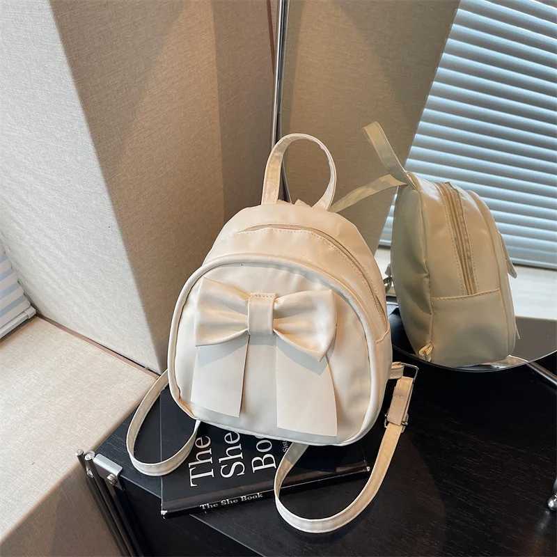 Summer 2025 new niche bow backpack for women stylish and simple handheld shoulder crossbody backpackT251016