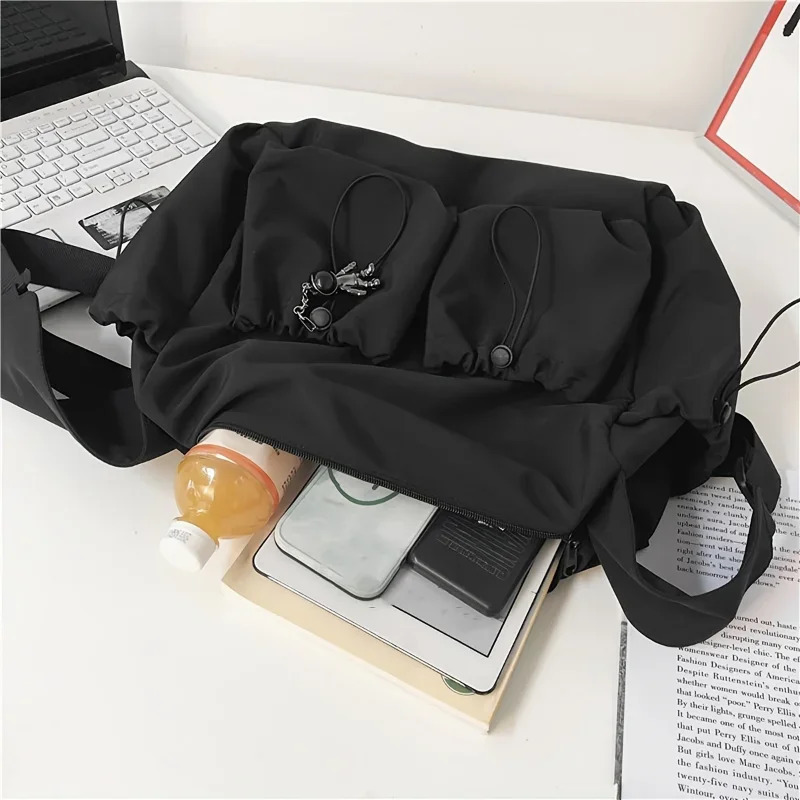 Fashionable Crossbody Bag with Drawstring Accent Spacious Secure Zipper Closure Includes Stylish Bag Charm 251014