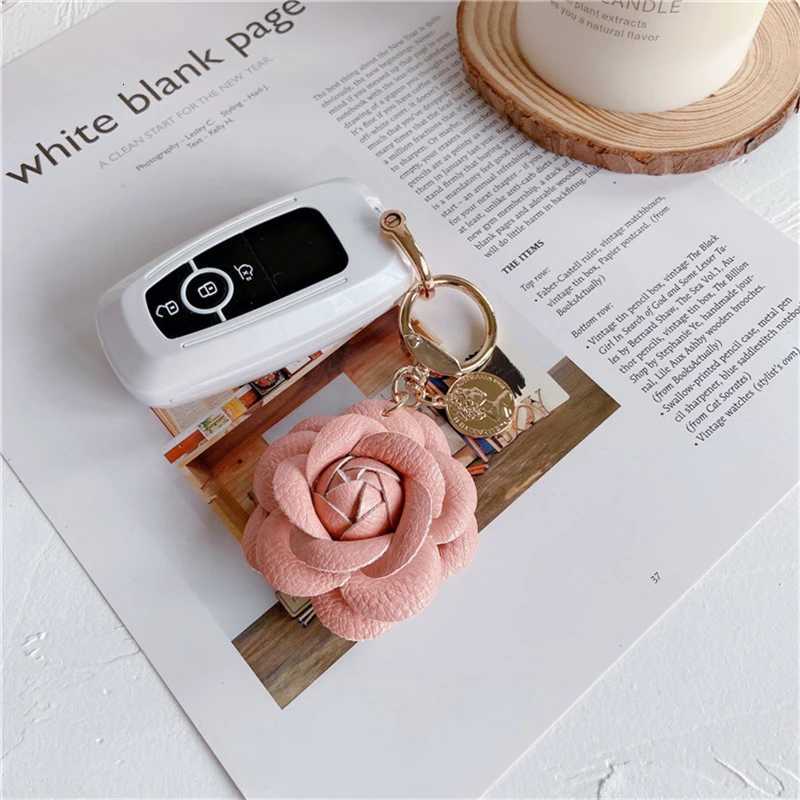 Luxury Black White Camellia Genuine Leather Flower Keychain Letter Umbrella Pendant Car Key Chain Ring Pendant For Bag Accessory W251021