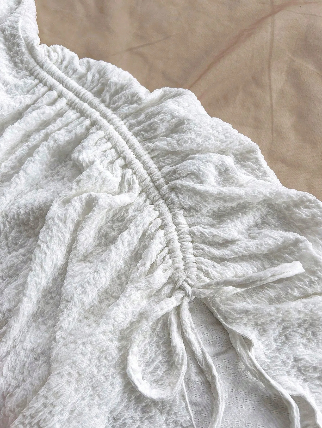 Spring and summer pure horn longsleeved hollowout dress with irregular pleats wrapped buttock to show leg length 251022