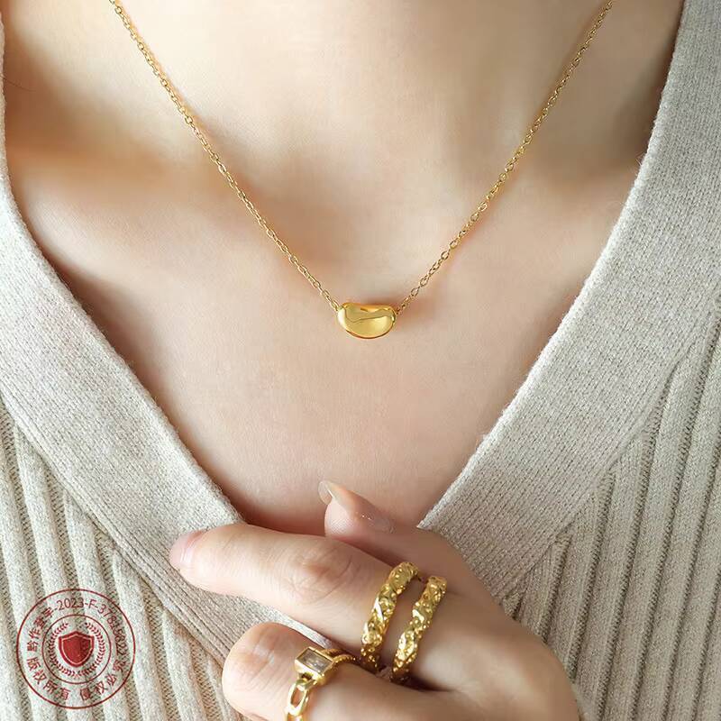 Hot Selling Womens Stainless Steel 18K Gold Plated Necklace Fashion Jewelry Chain with Lucky Golden Bean Pendant Zircon Stone