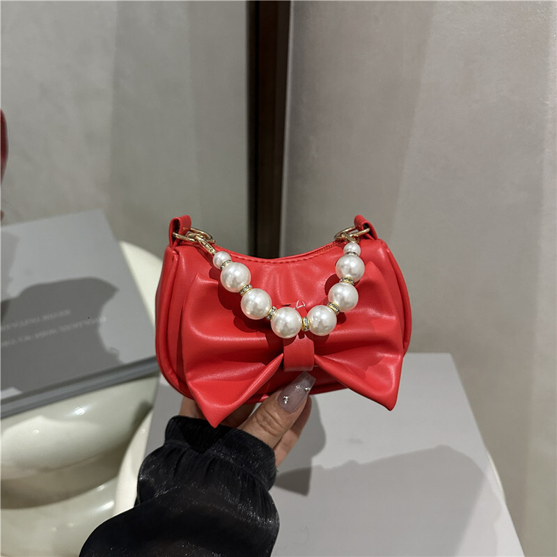 Sweet bow design handbag, winter new pearl chain design, fashionable and elegant women's shoulder bag, trendy and luxurious designer bag