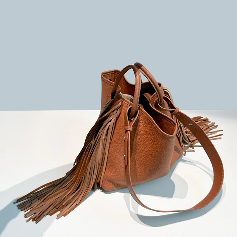 First layer cowhide tassel bucket bag niche n large capacity oneshoulder crossbody womens handbag 251014