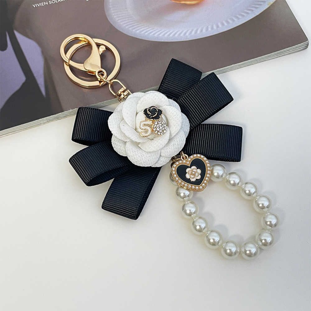 Highend Exquisite Korean Fashion Creative Camellia Ribbon Pearl Keychain Womens Bag Pendant Small Gift J251118